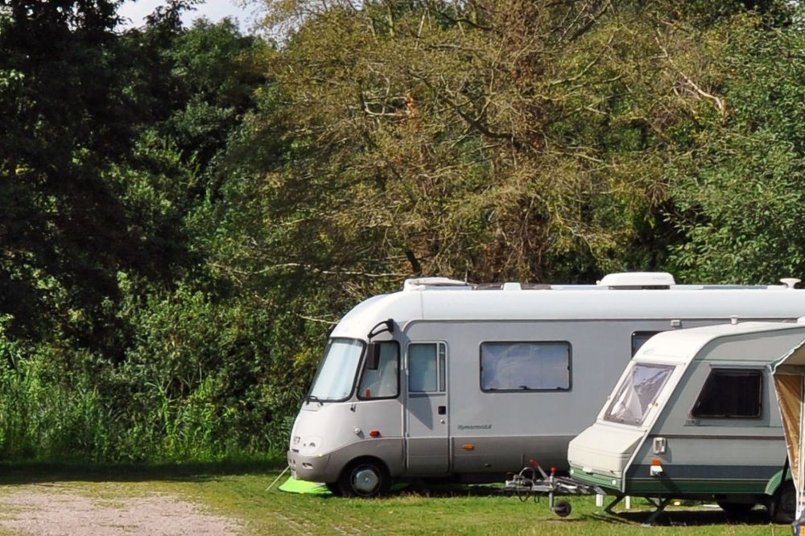 Two motorhome/caravan pitches side by side on a corner