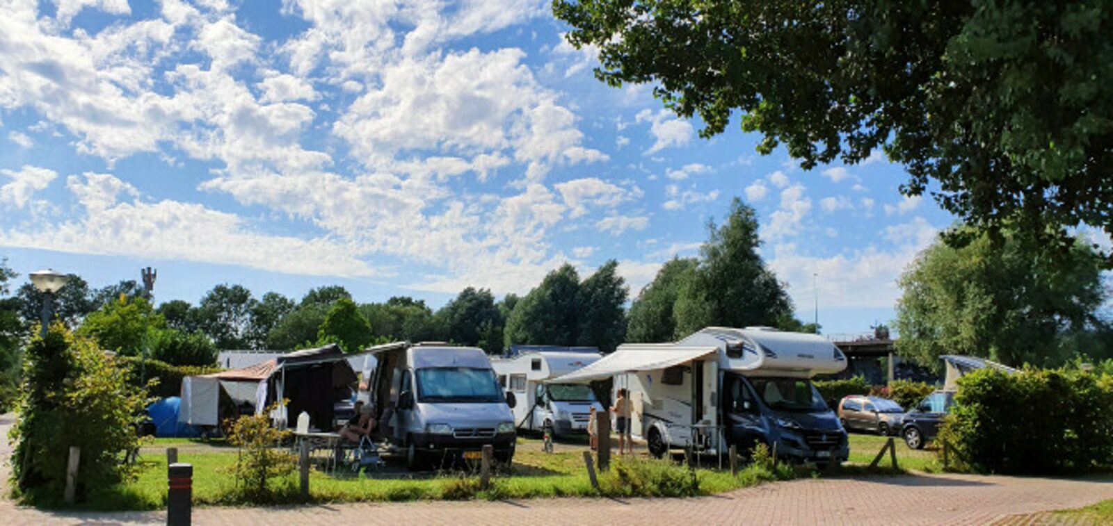 Two motorhome/caravan pitches side by side on a corner